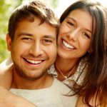 patients smiling after their dental implant procedures