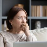 a women deciding whether to get dental implants or dentures
