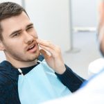 Dental Patient Suffering From Pain While On The Dental Chair